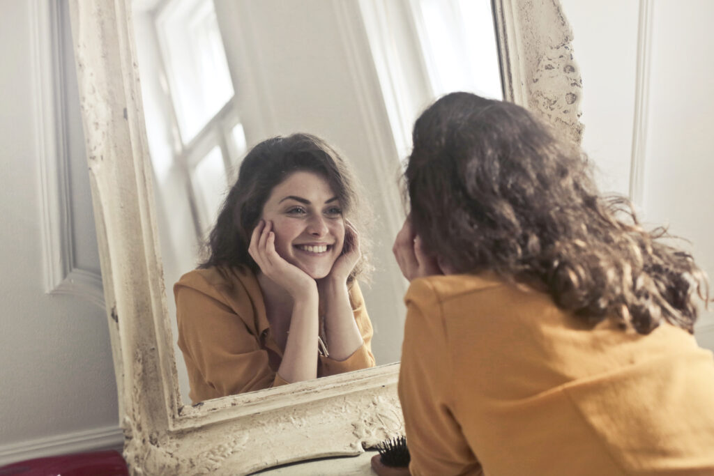 Photo of woman looking at the mirror